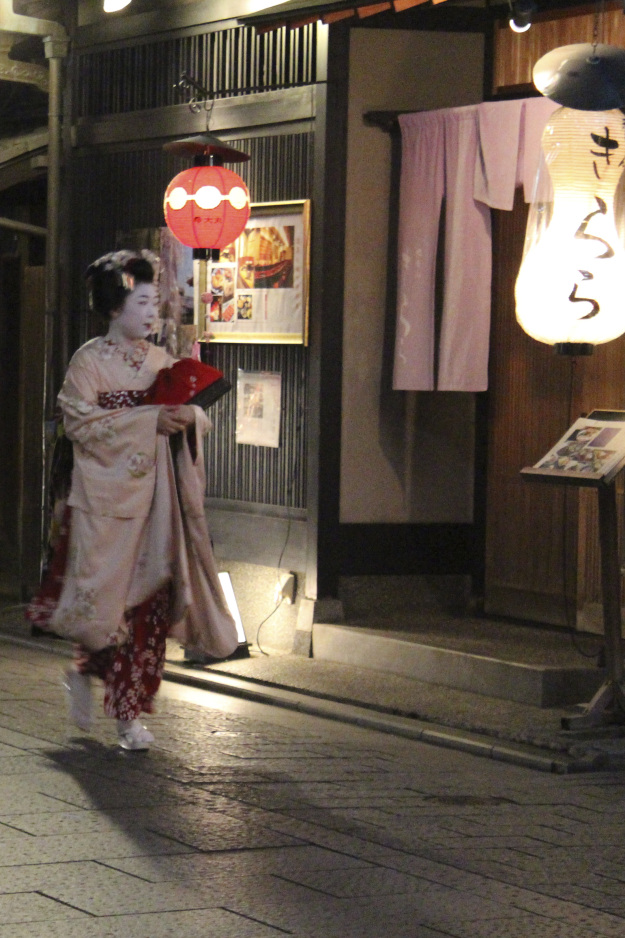 A geisha walking between engagements in the Gion district.