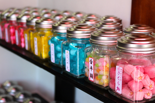 A row of colorful jars in a candy shop.