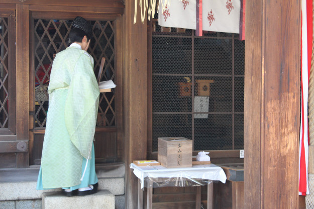 Priest about to perform a miyamairi, or a Shinto baptismal rite.