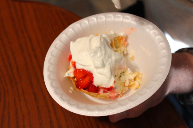 My dad's first sundae with a waffle bowl, birthday cake ice cream, strawberry sauce and vanilla bean whipped cream.