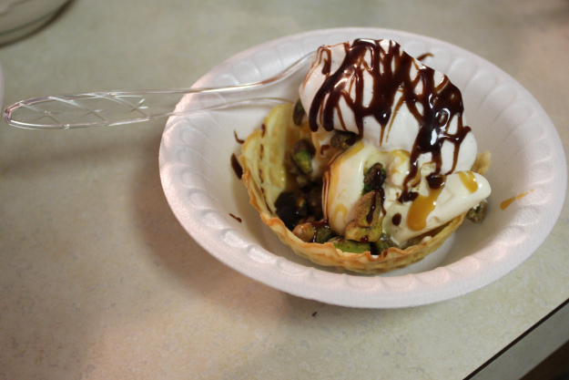 My sundae with a waffle bowl, vanilla ice cream, caramel sauce, pistachios, vanilla bean whipped cream and hot fudge.